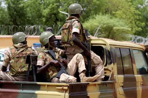 Members of the FAMA (Mali Armed Forces) patrol in the streets of Gao, on July 24, 2019, a day after suicide bombers in a vehicle painted with UN markings injured one French, several Estonian troops and two Malian civilians in an attack on an international peace-keeping base in Mali. - Malian authorities have struggled to improve security since France intervened in 2013 to drive back Islamic insurgents in the north. Around 4,000 French troops are deployed under Operation Barkhane alongside the MINUSMA peacekeeping force of around 15,000 soldiers and police. (Photo by Souleymane Ag Anara / AFP)
