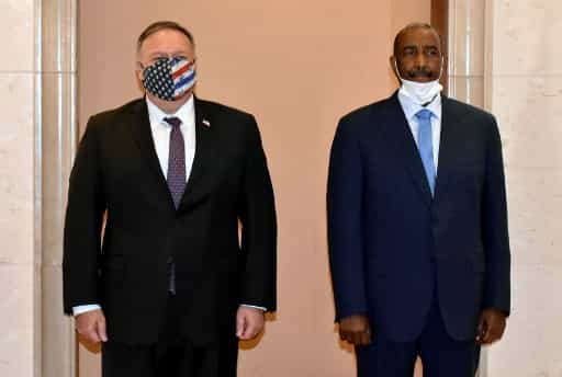 US Secretary of State Mike Pompeo (L) poses for a picture with Sudan's Sovereign Council chief General Abdel Fattah al-Burhan in Khartoum on August 25, 2020. - Pompeo is on an official visit to Sudan to urge more Arab countries to normalise ties with Israel, following the US-brokered Israel-UAE agreement. He is the first American top diplomat to visit Sudan since Condoleezza Rice went in 2005. (Photo by - / AFP)