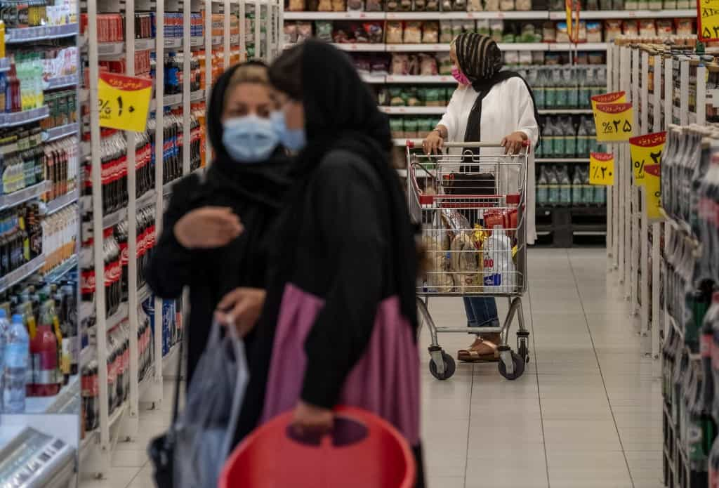 تورم - قیمت‌ها - گرانی Iranians shop for groceries at a hypermarket inside the Grand Bazaar (Iran Mall) in the western part of the capital Tehran, on June 20, 2021. - Iran's ultraconservatives hailed the election victory of their candidate Ebrahim Raisi, after Washington charged the vote was unfair and Tehran's arch-foe Israel labelled him the "most extremist" president yet.