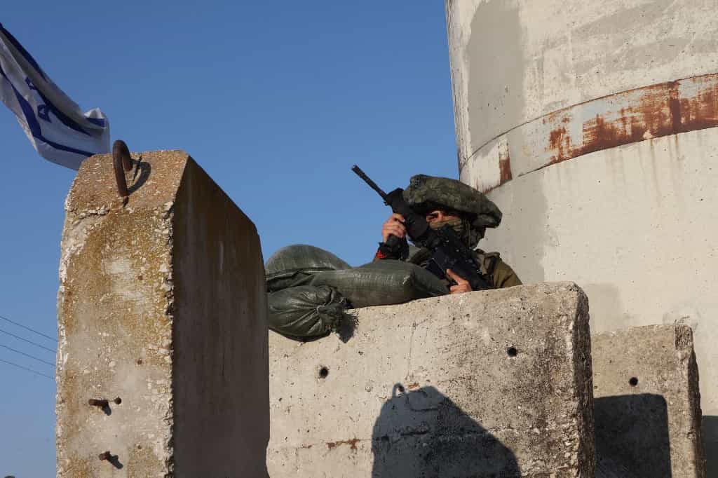 تصویر یک سرباز اسرائیلی که بر روی یک برجک مراقبت در نزدیکی اردوگاه جنین در فلسطین با اسنایپر در حال نشانهگیری است