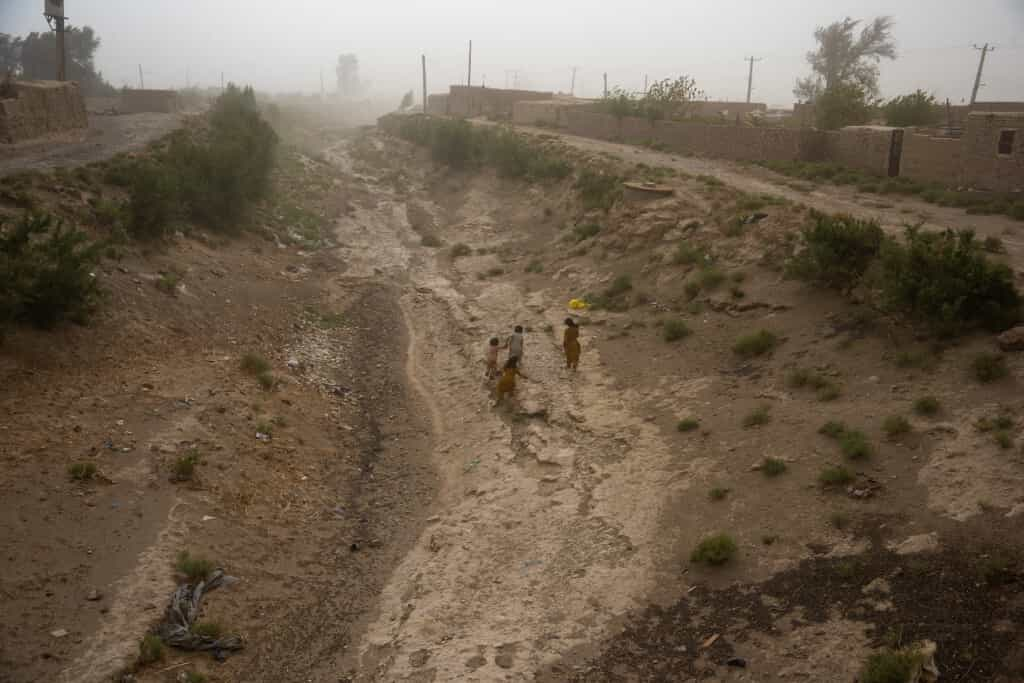 تصویر خبرگزاری فرانسه چند کودک را در بستر یک رودخانه خشک شده در جنوب شرقی ایران نشان می‌دهد.