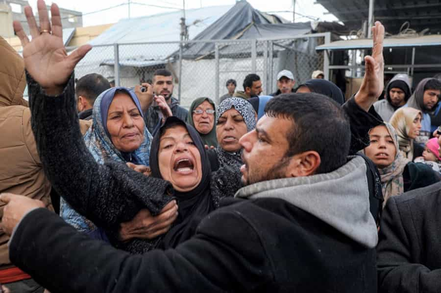 چند زن فلسطینی در حال شیون هستند و مردی آن‌ها را آرام می‌کند.