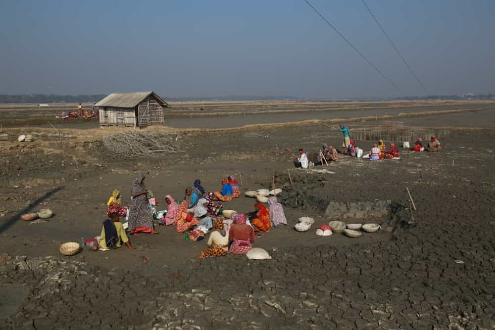 کارگران در حال استراحت در حال تعمیر سد پس از برخورد طوفان به مناطق ساحلی بنگلادش .